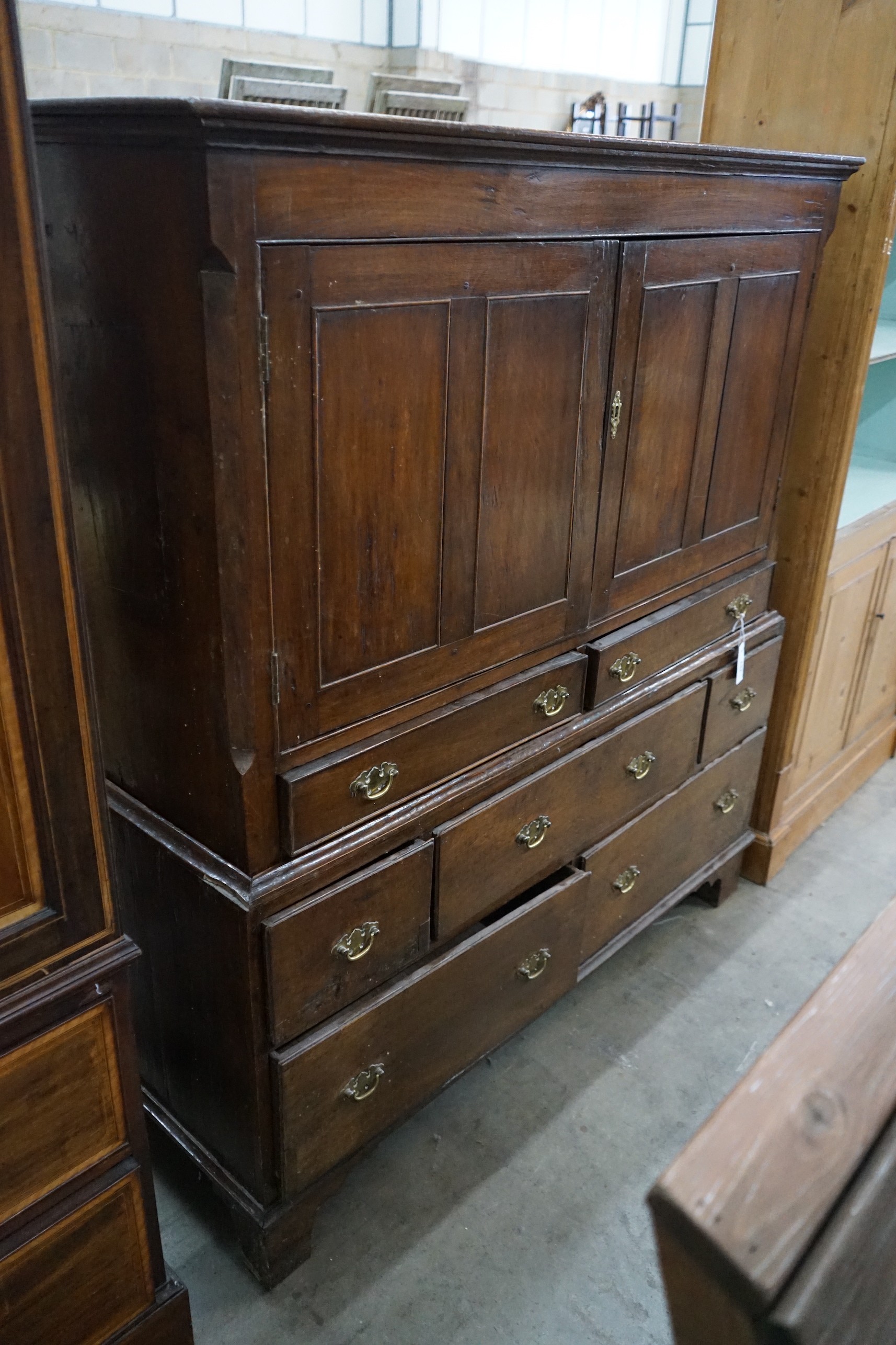 An 18th century oak two section press cupboard, width 127cm, depth 51cm, height 143cm